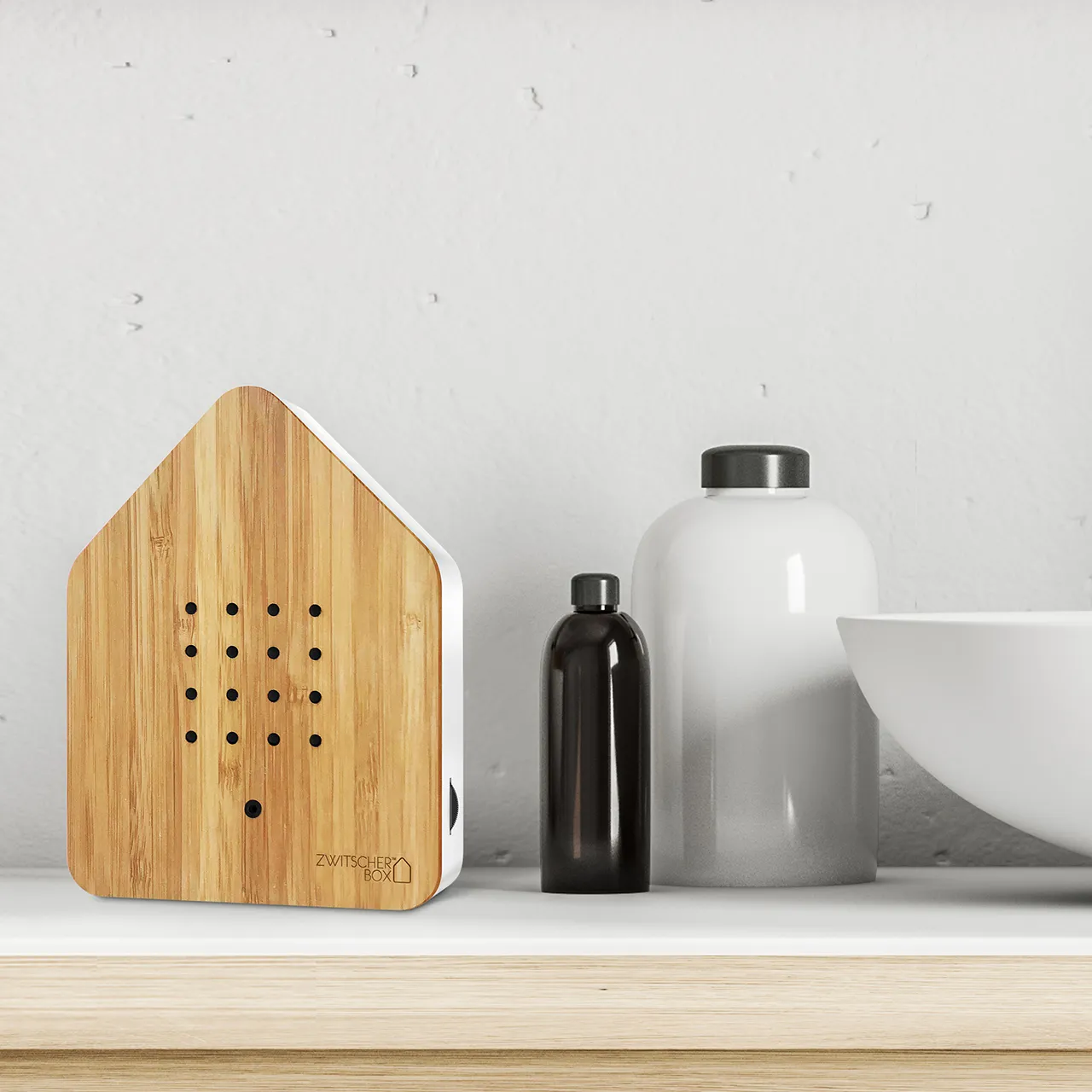 Bamboo Zwitscherbox on a bathroom counter next to the basin